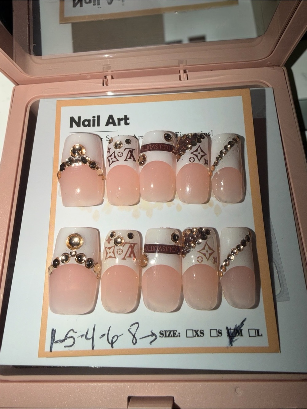 Luxury-Inspired Pink and White Nail Set with Gold Accents